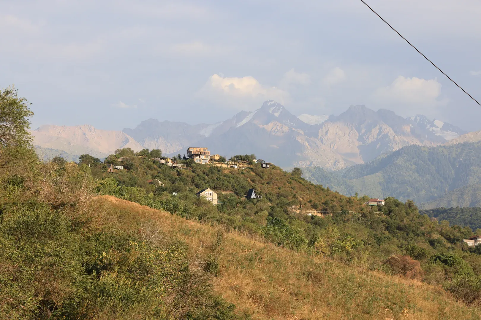 A view of the residential houses on the hill to the south of the pedestrian trail.