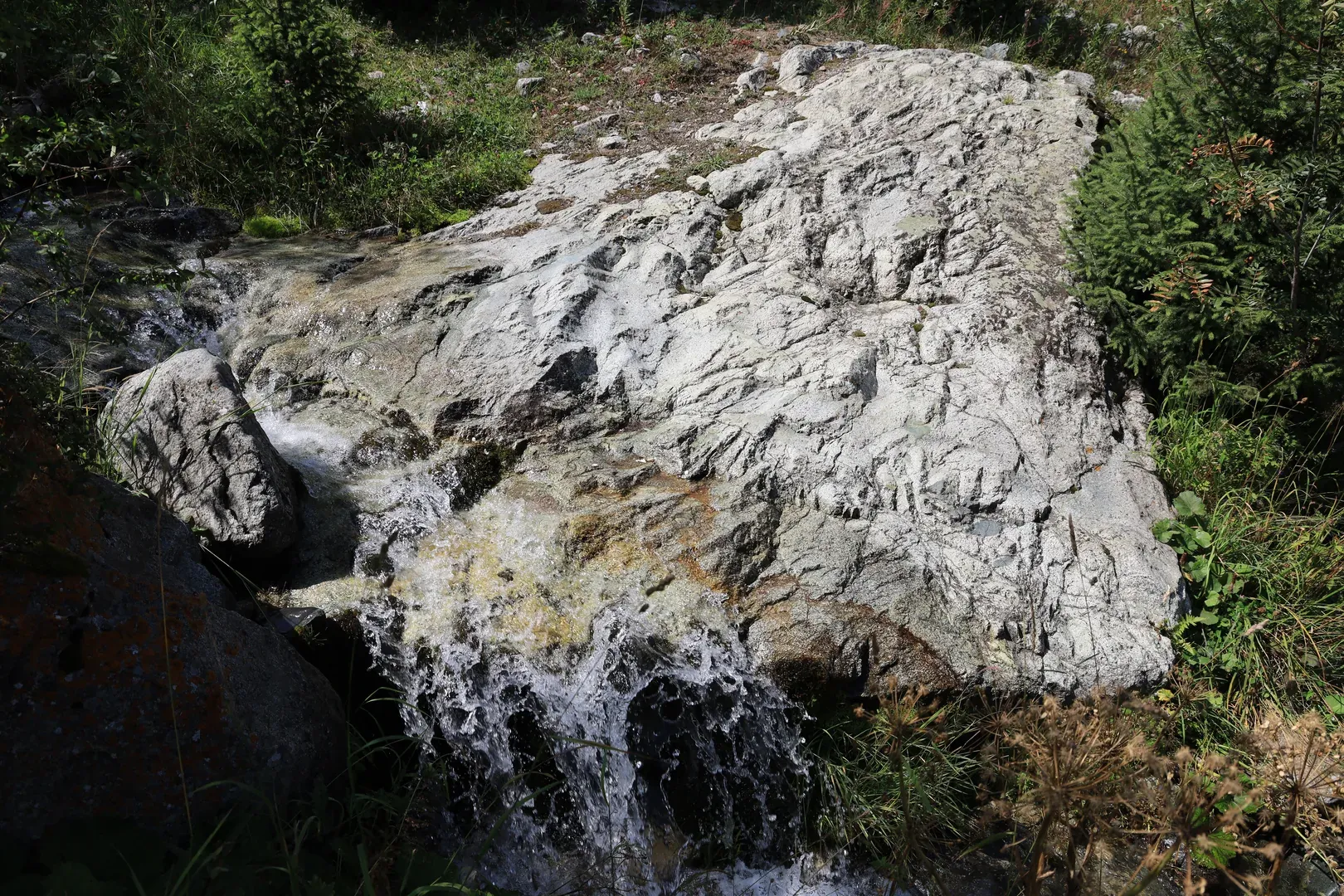 A view of both the stones and the river flowing down the mountain.